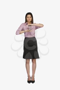 Portrait of a businesswoman holding an hourglass