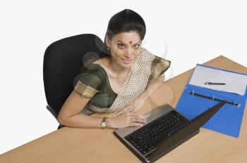 Businesswoman working on a laptop in an office
