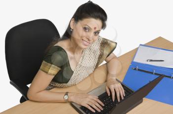 Businesswoman working on a laptop in an office