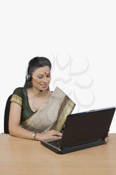 Female customer service representative working on a laptop
