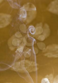 Incense smoke against colored background