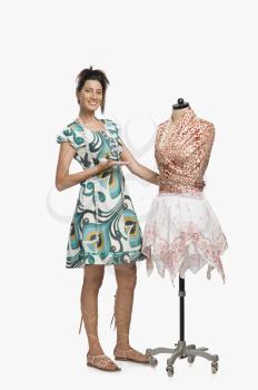 Female fashion designer showing a dress