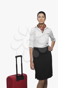 Portrait of an air hostess with her luggage