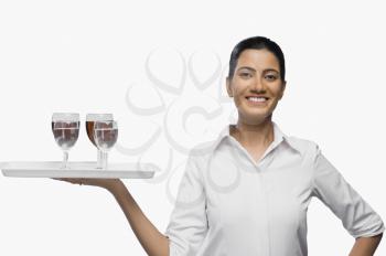 Air hostess carrying a tray of wine glasses
