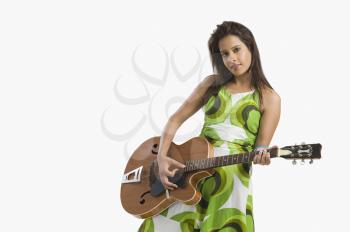 Woman playing a guitar and posing