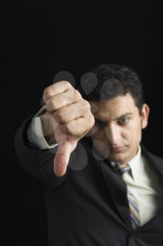 Businessman showing thumbs down sign