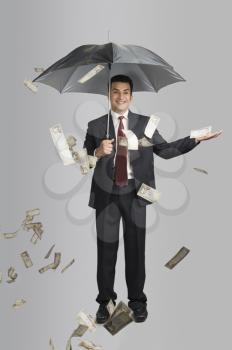 Money raining over a businessman
