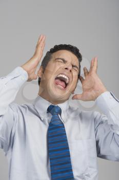 Businessman shouting with eye closed
