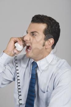 Businessman shouting over a telephone
