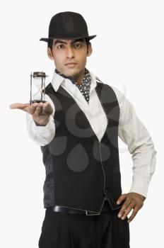 Businessman showing an hourglass