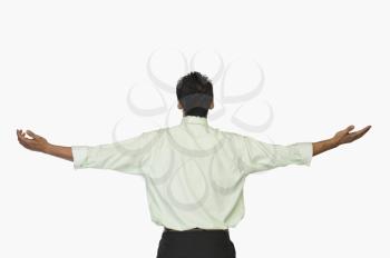 Rear view of a businessman with his arms outstretched