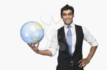 Portrait of a businessman holding a globe