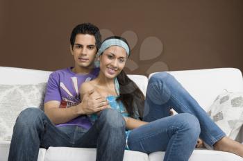 Couple sitting on a couch with arm around