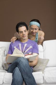 Couple reading a book together