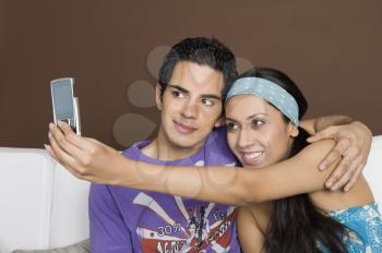 Couple taking a picture of themselves with a mobile phone