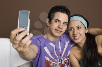 Couple taking a picture of themselves with a mobile phone