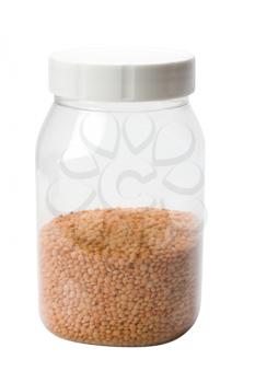 Close-up of red lentil in a plastic jar