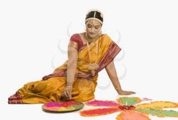 South Indian woman making rangoli
