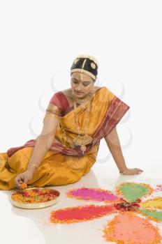 South Indian woman making rangoli