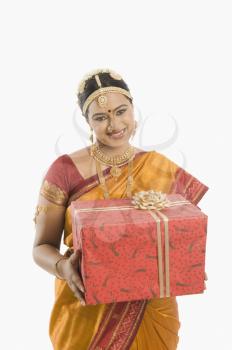 South Indian woman holding a gift box