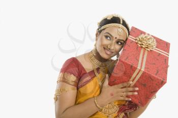 South Indian woman holding a gift box