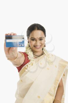 Woman showing a credit card and smiling