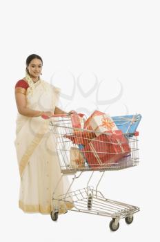 Woman carrying gifts in a shopping cart