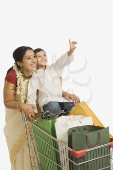 Woman with her son sitting on a shopping cart