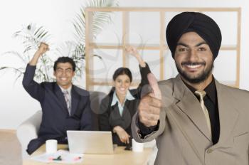 Businessman showing thumbs up sign