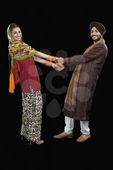 Portrait of a Sikh couple dancing