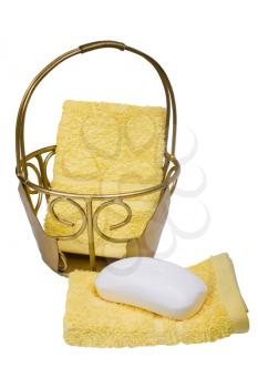 Close-up of bar of soap with towels and a basket