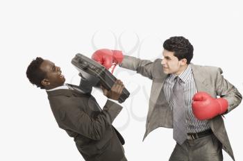 Businessman defending himself from the punch of his colleague