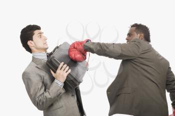 Businessman defending himself from the punch of his colleague
