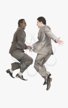 Two businessmen shaking hands in mid-air