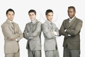Portrait of four businessmen standing with arms crossed