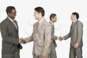 Four businessmen shaking hands