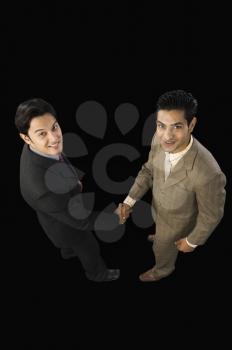 High angle view of two businessmen shaking hands