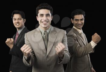 Portrait of three businessmen cheering