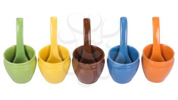 Assorted ceramic containers and soup spoons