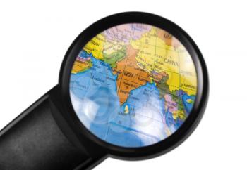 India on globe viewed through a magnifying glass