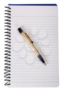 Close-up of a ballpoint pen on a spiral notebook