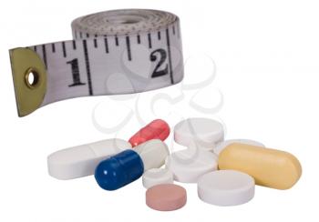 Close-up of pills with a tape measure