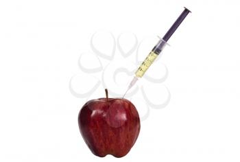 Syringe being injected into an apple