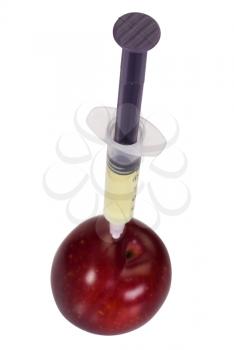 Syringe being injected into a plum