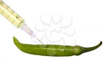 Green bell pepper being injected with a syringe