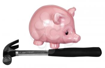 Close-up of a piggy bank and a hammer