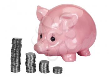 Close-up of a piggy bank and a stacks of coins