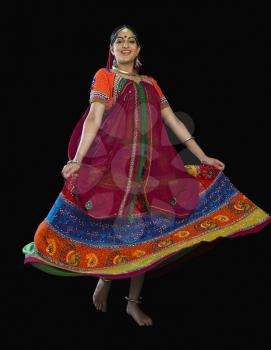 Woman dancing in colorful lehenga choli