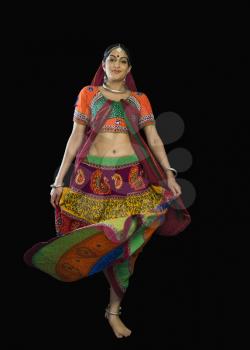 Woman in colorful lehenga choli dancing