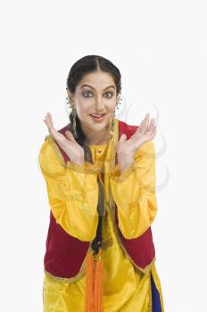 Woman in traditional Punjabi dress shrugging